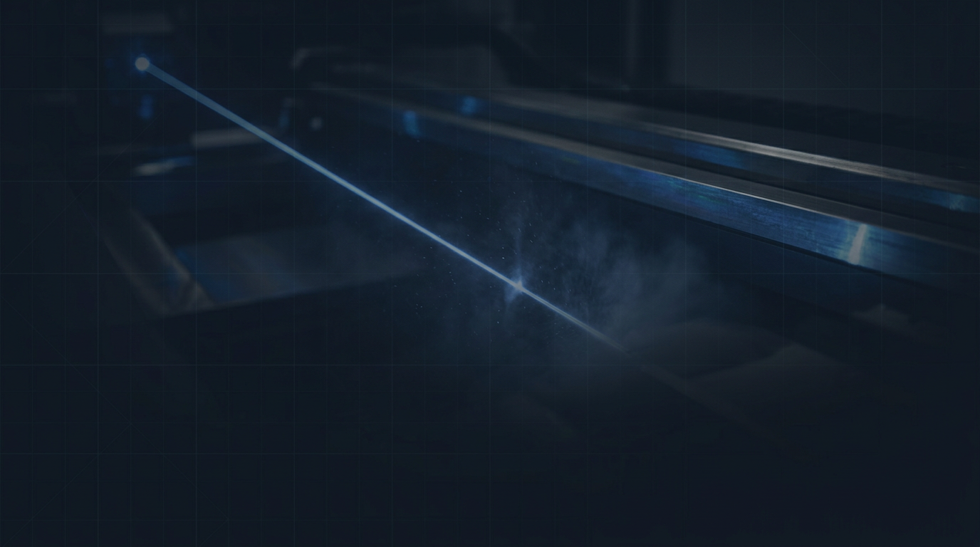 Dark industrial environment with diagonal electric blue laser beam cutting through atmosphere, metallic surfaces catching blue reflections, faint geometric grid suggesting precision measurement.